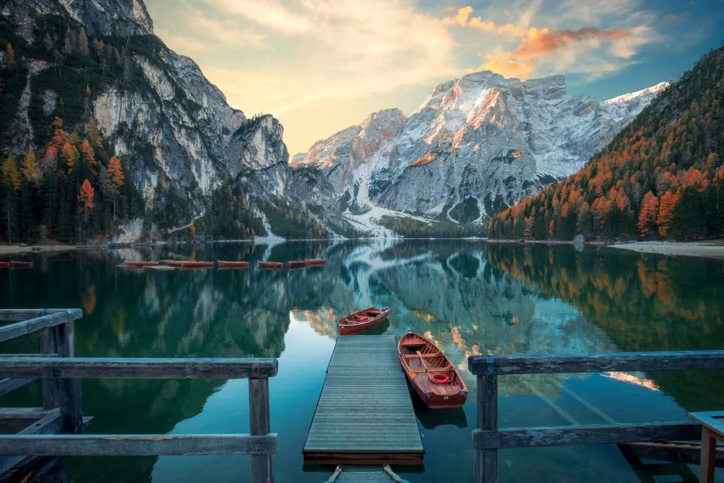Lago di Braies at sunrise, the Alta Via 1's starting point, with the Dolomites reflected in the water